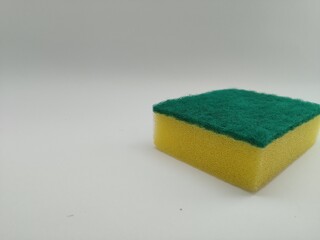 Yellow plate cleaning sponge on white background
