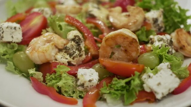 Plate Of Appetizing Salad With Shrimp Tomatoes Cheese And Lettuce.