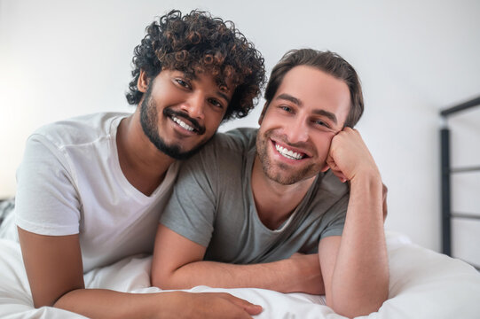 Affectionate Indian man embracing his Caucasian boyfriend - Powered by Adobe