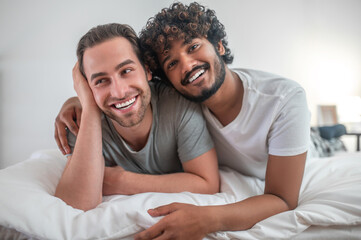 Romantic male hugging his happy Caucasian partner