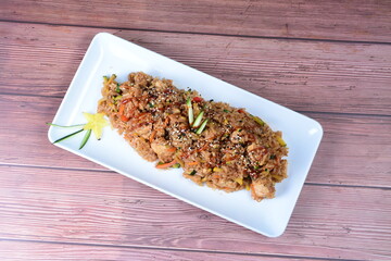 Sauteed wok rice, accompanied by beef tenderloin, vegetables, chicken, sesame, soy sauce and teriyaki
