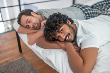 Male and his boyfriend resting in their bedroom