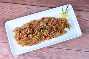 Sauteed wok rice, accompanied by beef tenderloin, vegetables, chicken, sesame, soy sauce and teriyaki