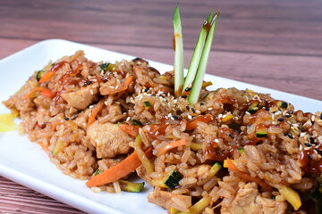 Sauteed wok rice, accompanied by beef tenderloin, vegetables, chicken, sesame, soy sauce and teriyaki