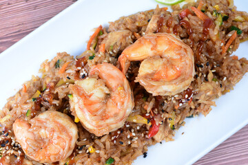 Sauteed wok rice, accompanied by beef tenderloin, vegetables, chicken, sesame, soy sauce and teriyaki