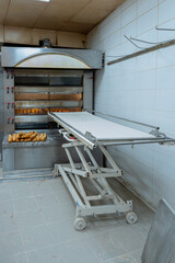 Gennevilliers, France - 03 11 2022: Artisan baker and pastry chef. French baguette baking in the bread oven in a bakery