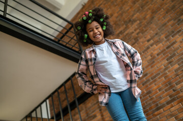 Bottom view of girl smiling at camera at home