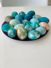 beautiful Easter multi-colored mother-of-pearl eggs for Easter on a white background. Happy easter greeting card. Copy space.