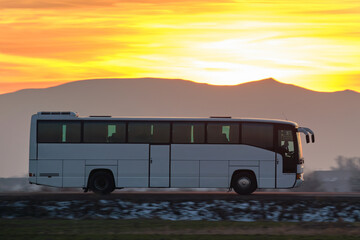 Intercity passenger bus driving on highway road in evening © bilanol