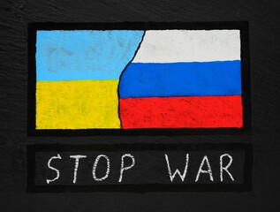 The flag of Ukraine and Russia hand-painted on a black textured background. War between Russia and Ukraine. Stop the war .