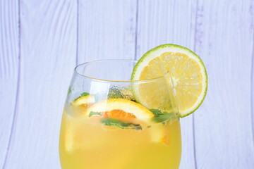 Refreshing orange drink, lemon and mint leaves