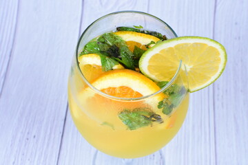 Refreshing orange drink, lemon and mint leaves