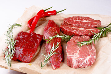 Rib Eye Steak, Striploin Steak, Butterfly Steak made of marble raw beef lie on the board