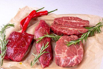 Rib Eye Steak, Striploin Steak, Butterfly Steak made of marble raw beef lie on the board