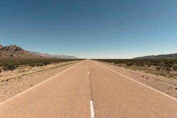 Tarmac road vanishing into the distance in the desert of San Juan, Argentina.
