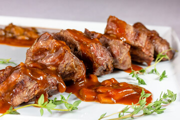 Beef kebab with tomato sauce with vegetables is on a plate