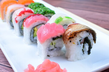 Traditional colorful suhi, cream cheese, salmon, caviar, rool sishi crunch, sesame seeds and sauce