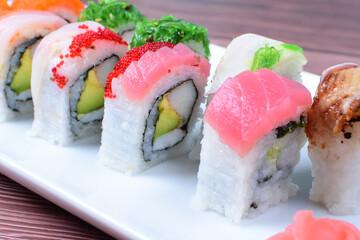 Traditional colorful suhi, cream cheese, salmon, caviar, rool sishi crunch, sesame seeds and sauce