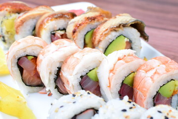 Traditional colorful suhi, cream cheese, salmon, caviar, rool sishi crunch, sesame seeds and sauce