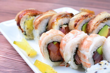 Traditional colorful suhi, cream cheese, salmon, caviar, rool sishi crunch, sesame seeds and sauce