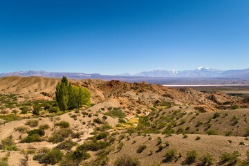 Arid hills in natural reserve El Leoncito, in the province of San Juan, Argentina. The Andes mountains can be seen in the back.