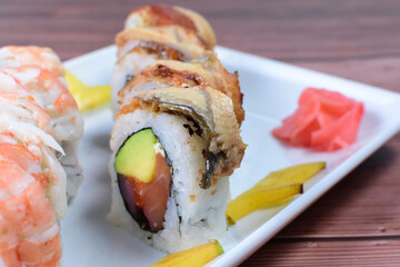 Traditional colorful suhi, cream cheese, salmon, caviar, rool sishi crunch, sesame seeds and sauce