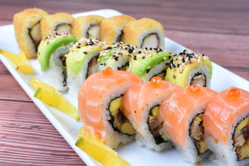 Traditional colorful suhi, cream cheese, salmon, caviar, rool sishi crunch, sesame seeds and sauce