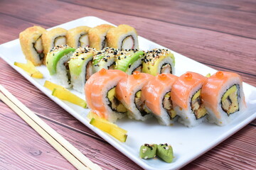 Traditional colorful suhi, cream cheese, salmon, caviar, rool sishi crunch, sesame seeds and sauce