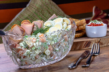 Olivier. Traditional Russian salad of boiled vegetables with meat and mayonnaise in a large salad bowl.