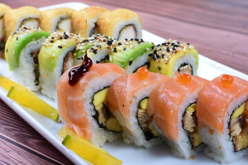 Traditional colorful suhi, cream cheese, salmon, caviar, rool sishi crunch, sesame seeds and sauce