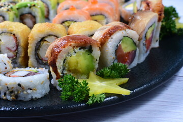 Traditional colorful suhi, cream cheese, salmon, caviar, rool sishi crunch, sesame seeds and sauce