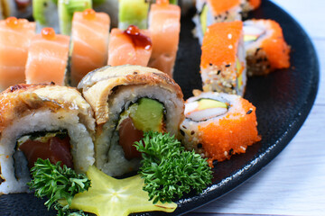 Traditional colorful suhi, cream cheese, salmon, caviar, rool sishi crunch, sesame seeds and sauce
