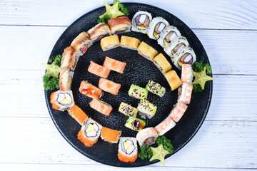 Traditional colorful suhi, cream cheese, salmon, caviar, rool sishi crunch, sesame seeds and sauce