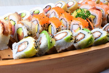Traditional colorful suhi, cream cheese, salmon, caviar, rool sishi crunch, sesame seeds and sauce