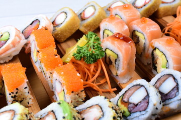 Traditional colorful suhi, cream cheese, salmon, caviar, rool sishi crunch, sesame seeds and sauce