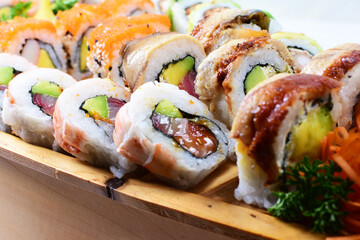 Traditional colorful suhi, cream cheese, salmon, caviar, rool sishi crunch, sesame seeds and sauce