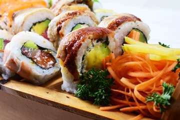 Traditional colorful suhi, cream cheese, salmon, caviar, rool sishi crunch, sesame seeds and sauce
