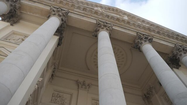 A low angle view of the massive columns of an old building.