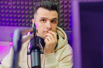 pensive professional radio host broadcasts live reads news 