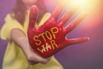 on females hand painted in red text Stop war of Ukraine