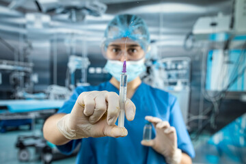 Portrait of female doctor in uniform, gloves face mask prepare syringe with antibiotic