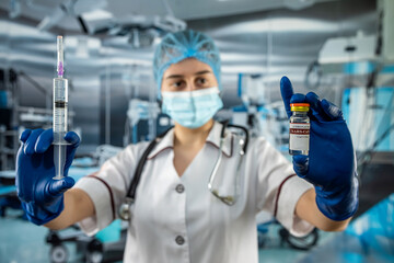 Portrait of female doctor in uniform, gloves face mask prepare syringe with antibiotic - obrazy, fototapety, plakaty
