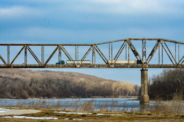 two trucks driving on  bridge  over a river