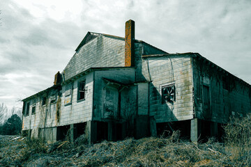Fototapeta na wymiar spooky haunted abandoned factory warehouse scary foreboding dangerous building