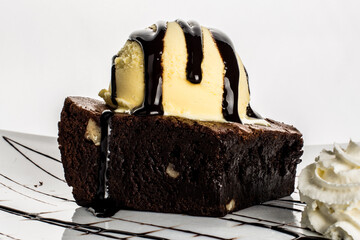 Brownie cake with vanilla ice cream and chocolate syrup