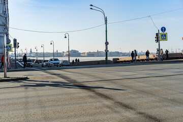 22.03.2022 14:15 pm Russia St. Petersburg Perkrestok Liteiny bridge and palace embankment. Monument to the Commander Suvorov. City car traffic in the afternoon. Pedestrian crossings.