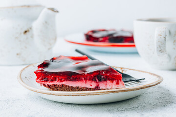 Cake with berry jell with blueberries and raspberries on a white background