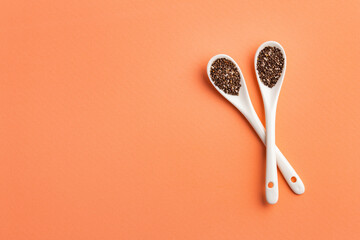 Organic chia seeds in two ceramic spoons - Salvia hispánica