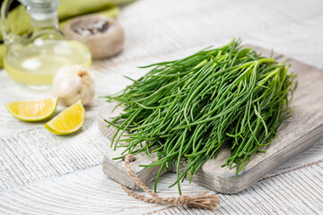Fresh Agretti or barba dei frati, edible green plant. Saltwort, barilla plant or salsola soda.