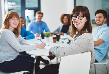 Young movers and shakers. Cropped portrait of a group of young businesspeople sitting in a boardroom during a meeting.